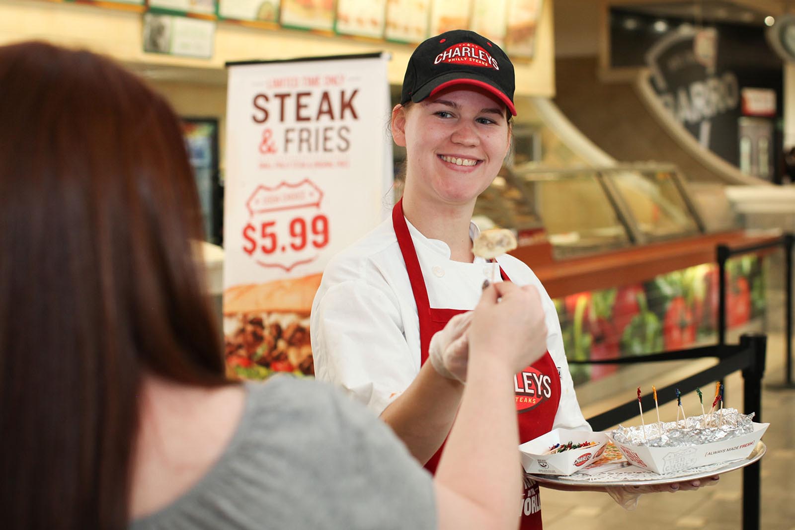 Charleys franchise employee giving out samples